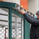 worker painting awning for outdoor dining